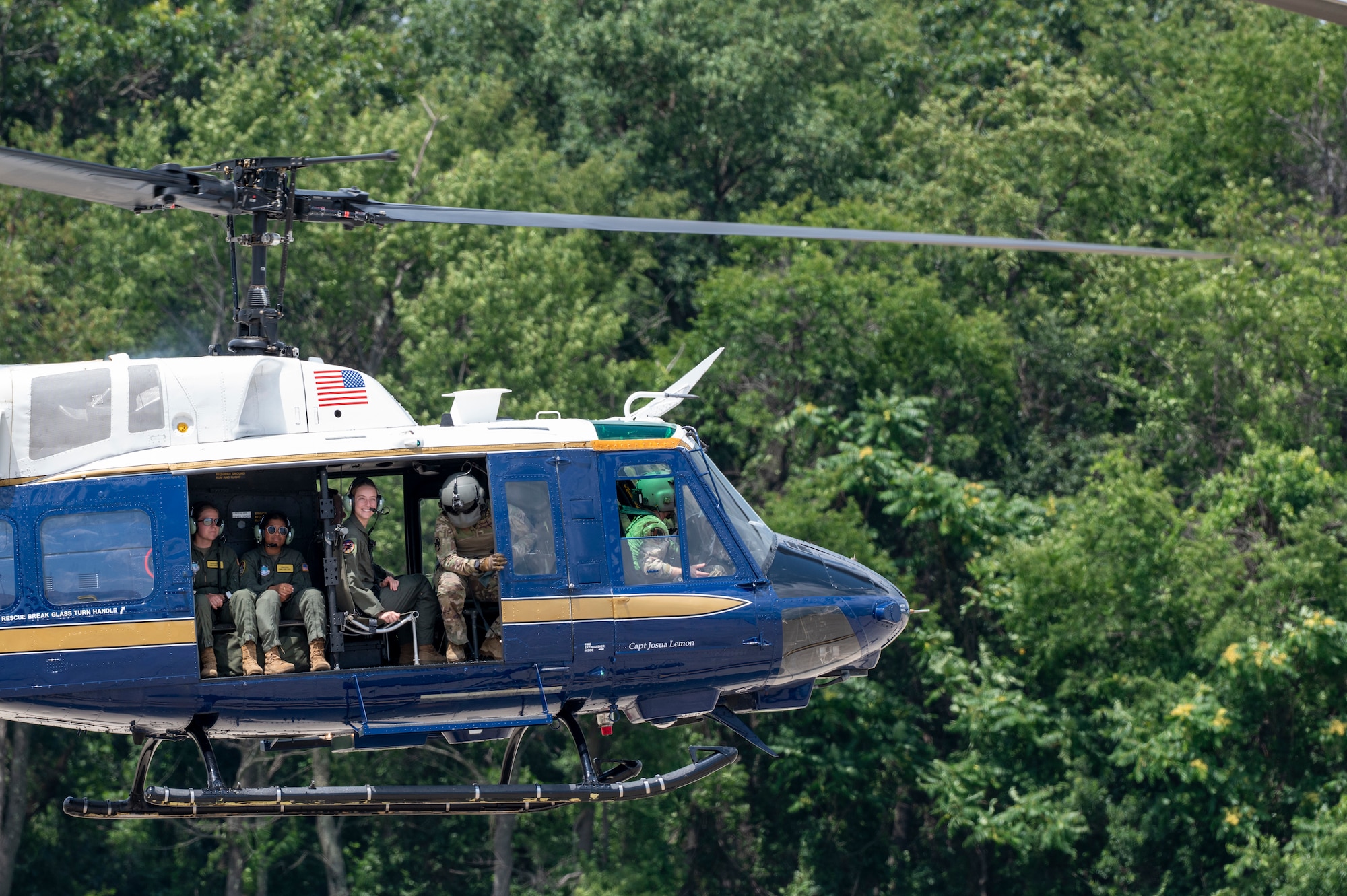 U.S. Airmen from the 1st Helicopter Squadron and cadets from the U.S. Air Force Academy fly in a UH-1N Huey helicopter during a tour of the 1st HS at Joint Base Andrews, Md., July 17, 2025. Cadets visited JBA and Joint Base Anacostia-Bolling, Washington, D.C., as part of USAFA’s Summer Operations program to learn more about officer life and the operational Air Force. (U.S. Air Force photo by Hayden Hallman)
