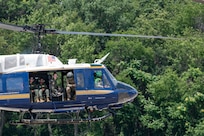 U.S. Airmen from the 1st Helicopter Squadron and cadets from the U.S. Air Force Academy fly in a UH-1N Huey helicopter during a tour of the 1st HS at Joint Base Andrews, Md., July 17, 2025. Cadets visited JBA and Joint Base Anacostia-Bolling, Washington, D.C., as part of USAFA’s Summer Operations program to learn more about officer life and the operational Air Force. (U.S. Air Force photo by Hayden Hallman)