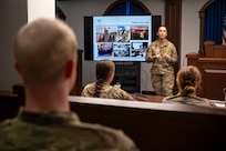 U.S. Air Force Capt. Erin Carnick, judge advocate with the 11th Wing Office of the Staff Judge Advocate, delivers a presentation about Air Force legal operations to cadets from the U.S. Air Force Academy at Joint Base Anacostia-Bolling, Washington, D.C., July 18, 2025. Cadets visited JBAB as part of USAFA’s Summer Operations program to learn more about officer life and the operational Air Force. (U.S. Air Force photo by Hayden Hallman)