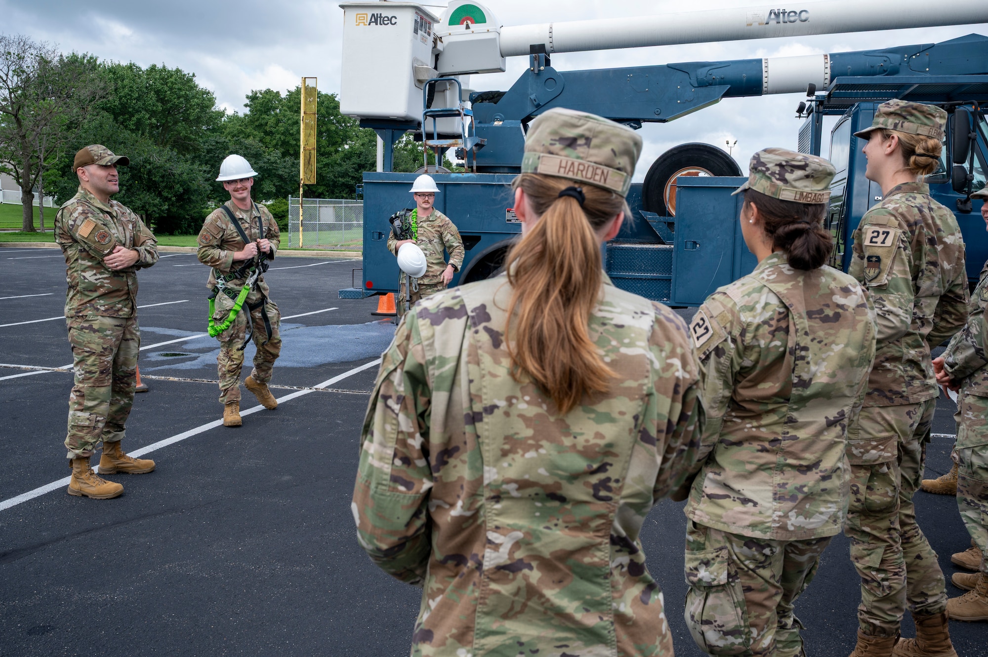 From left, U.S. Air Force Master Sgt. Alejandro Alba, operations engineering superintendent, Senior Airman Brady Steelman, electrical systems journeyman, and Staff Sgt. Alex Vanskiver, an electrical systems supervisor, all from the 11th Civil Engineer Squadron, brief cadets from the U.S. Air Force Academy on the aerial lift truck at Joint Base Anacostia-Bolling, Washington, D.C., July 15, 2025. Cadets visited JBAB as part of USAFA’s Summer Operations program to learn more about officer life and the operational Air Force. (U.S. Air Force photo by Hayden Hallman)