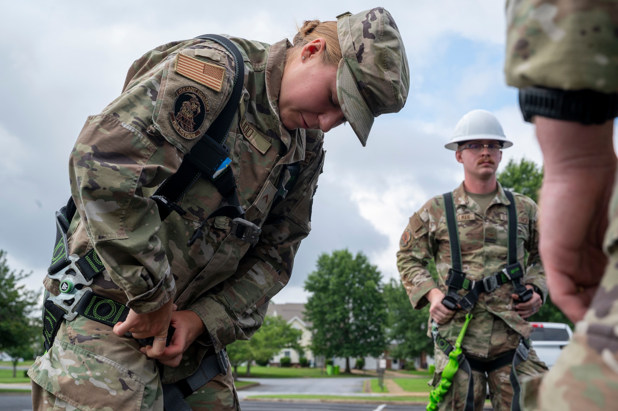 U.S. Air Force Academy Cadet Caitlyn Budd dons a safety harness during a demonstration of 11th Civil Engineer Squadron equipment at Joint Base Anacostia-Bolling, Washington, D.C., July 15, 2025. Cadets visited JBAB as part of USAFA’s Summer Operations program to learn more about officer life and the operational Air Force. (U.S. Air Force photo by Hayden Hallman)