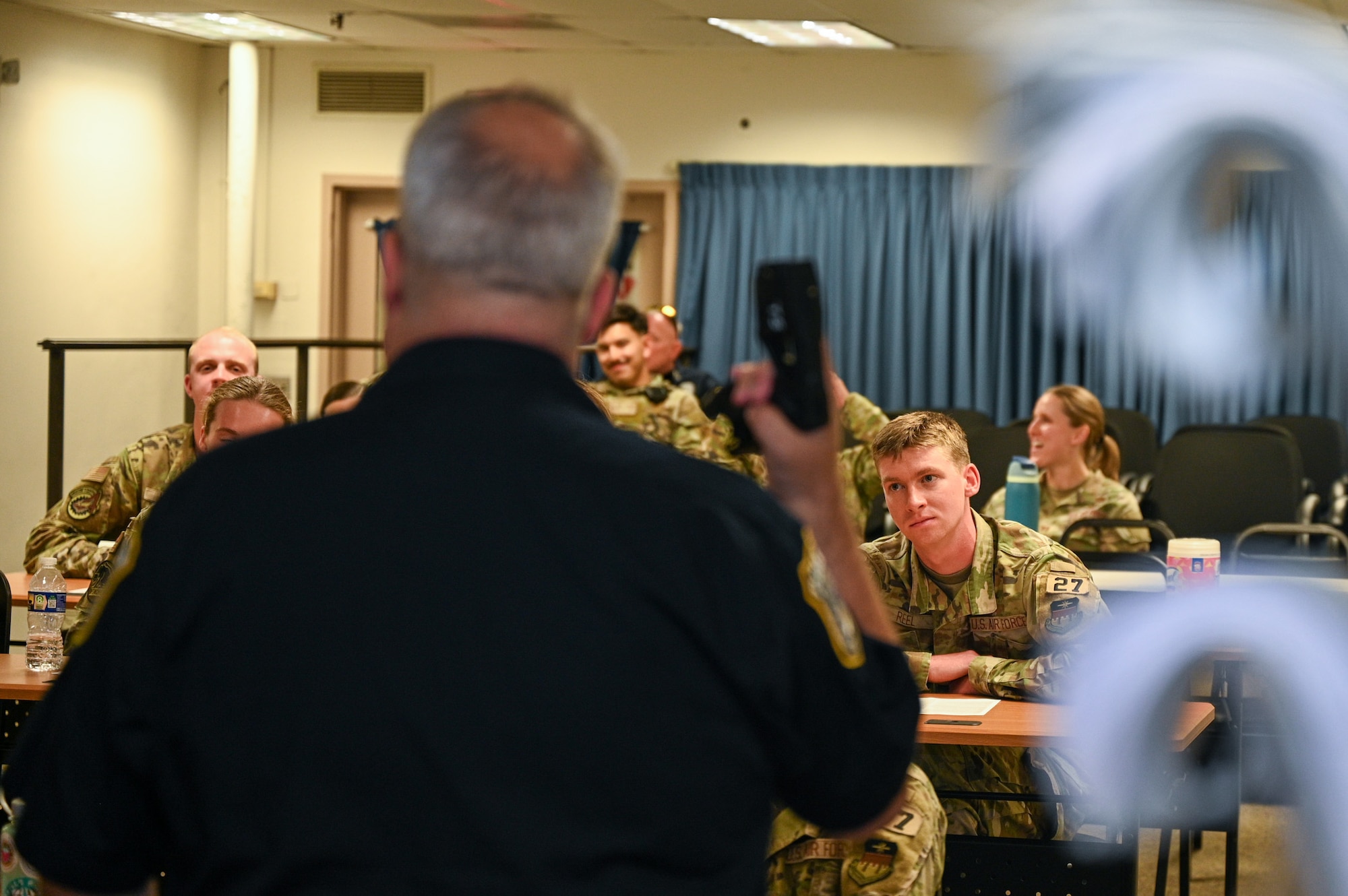 Sgt. 1st Class Lance LaRue, a police trainer with the 11th Security Forces Squadron, instructs a class of U.S. Air Force Academy cadets during a USAFA Summer Operations visit at Joint Base Anacostia-Bolling, Washington, D.C., July 16, 2025. The class began with a lecture portion and participants signed a waiver agreeing to be tased for a hands-on training event. (U.S. Air Force photo by Airman 1st Class Shanel Toussaint)