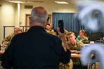 Sgt. 1st Class Lance LaRue, a police trainer with the 11th Security Forces Squadron, instructs a class of U.S. Air Force Academy cadets during a USAFA Summer Operations visit at Joint Base Anacostia-Bolling, Washington, D.C., July 16, 2025. The class began with a lecture portion and participants signed a waiver agreeing to be tased for a hands-on training event. (U.S. Air Force photo by Airman 1st Class Shanel Toussaint)