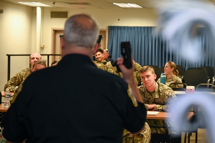 Sgt. 1st Class Lance LaRue, a police trainer with the 11th Security Forces Squadron, instructs a class of U.S. Air Force Academy cadets during a USAFA Summer Operations visit at Joint Base Anacostia-Bolling, Washington, D.C., July 16, 2025. The class began with a lecture portion and participants signed a waiver agreeing to be tased for a hands-on training event. (U.S. Air Force photo by Airman 1st Class Shanel Toussaint)