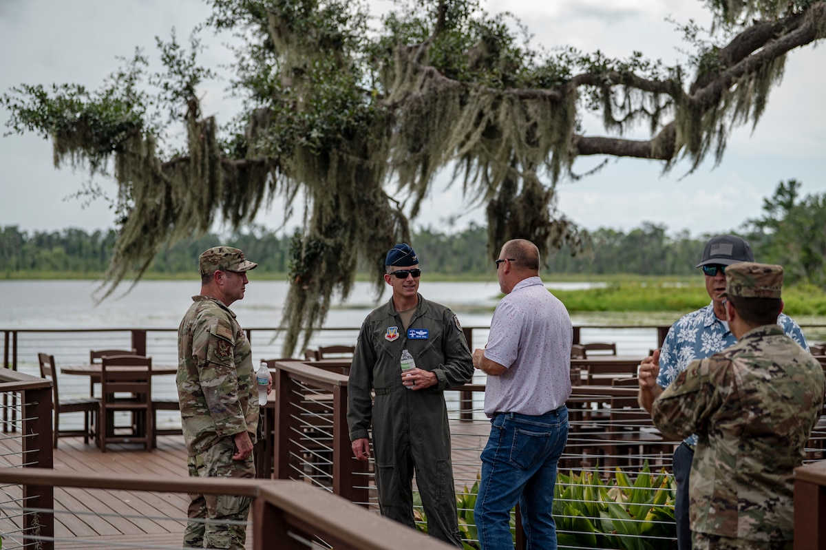 U.S. Air Force Col. Paul Sheets, 23rd Wing commander, left, and Col. Sean Hall, 23rd Wing incoming commander, second from left, receive an update on the progress of the Grassy Pond Recreation Area rebuild in Lake Park, Georgia, July 18, 2025. Wing leadership discussed completed repairs and ongoing construction across the site. (U.S. Air Force photo by Senior Airman Leonid Soubbotine)