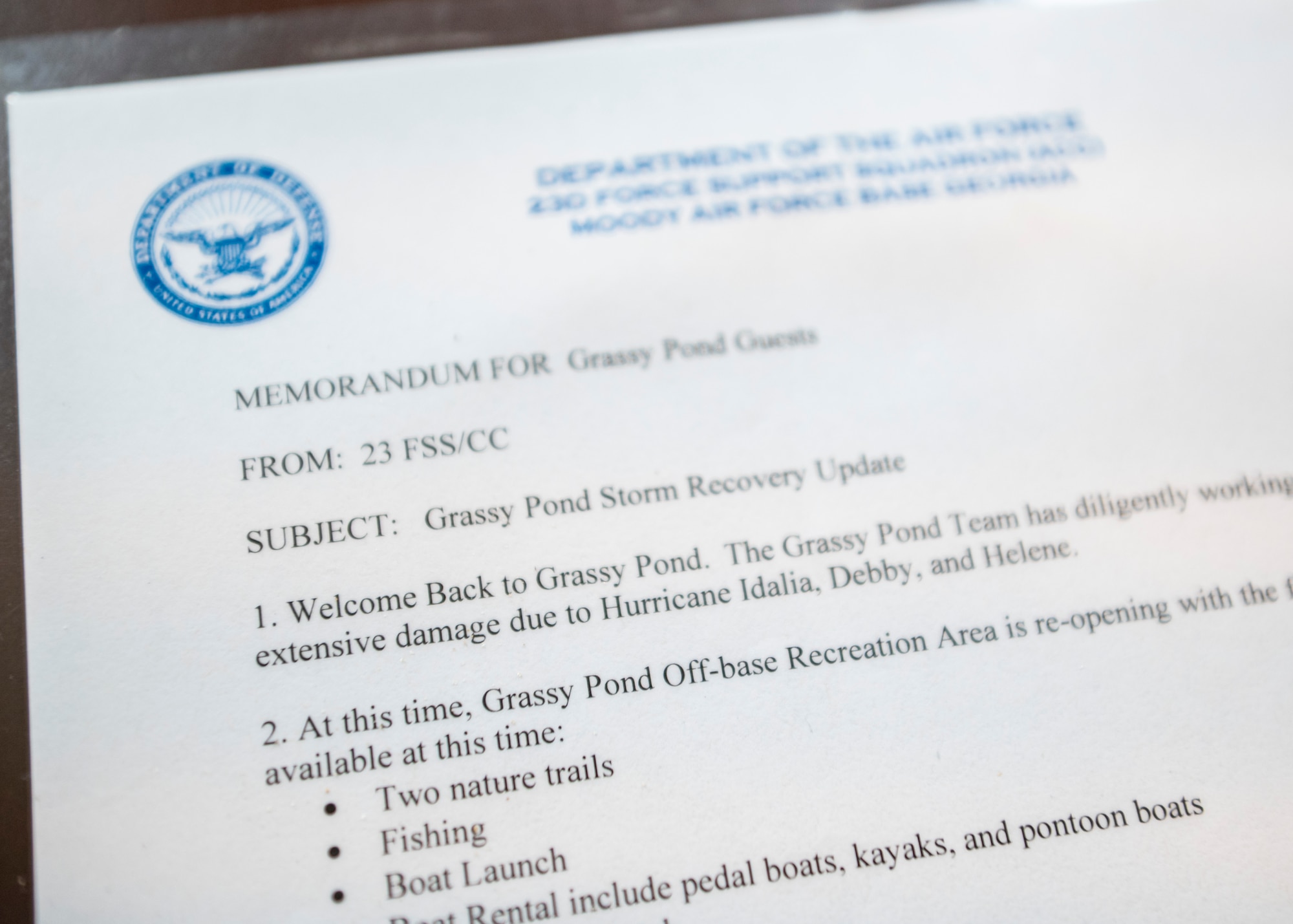 A memorandum detailing the phased reopening of Grassy Pond Recreation Area is on a desk in Lake Park, Georgia, July 18, 2025. The document outlines ongoing repairs and upcoming improvements following Hurricane Helene damage, including new cabins, upgraded docks, and expanded amenities. (U.S. Air Force photo by Senior Airman Leonid Soubbotine)