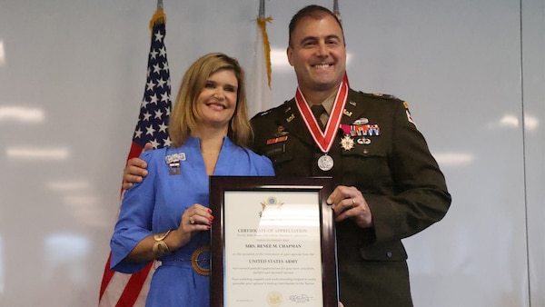 U.S. Army Corps of Engineers, Mobile District commander Col. Jeremy Chapman poses with his wife Renee Chapman after she receives her retirement certificate during Chapman’s retirement ceremony at the Mobile District Headquarters