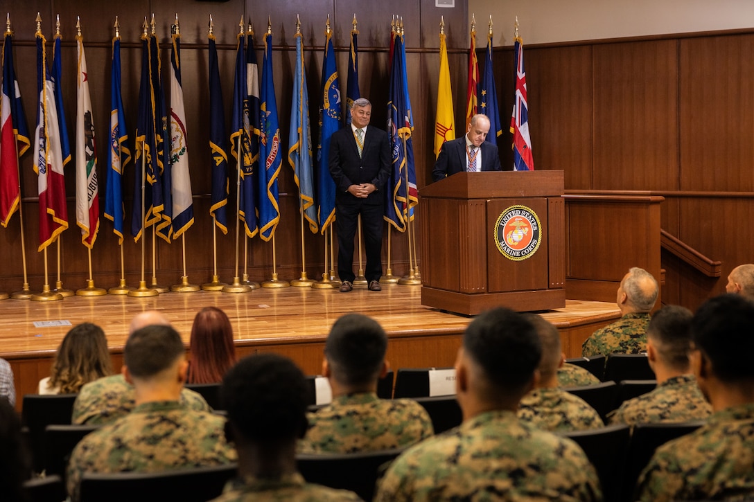 Gregg Habel, left, executive director of Marine Forces Reserve (MARFORRES) and Marine Forces South, and Joe Garcia, right, MARFORRES assistant deputy chief of staff G-1, addresses uniformed and civilian Marines of MARFORRES during the Marine Forces Reserve 2024 Civilian of the Year awards at Marine Corps Support Facility, New Orleans, July 23, 2025. The Civilian of the Year awards recognizes civilian Marines whose outstanding service and dedication have made a long-lasting impact at MARFORRES. (U.S. Marine Corps Photo by Lance Cpl. Edward Spears)