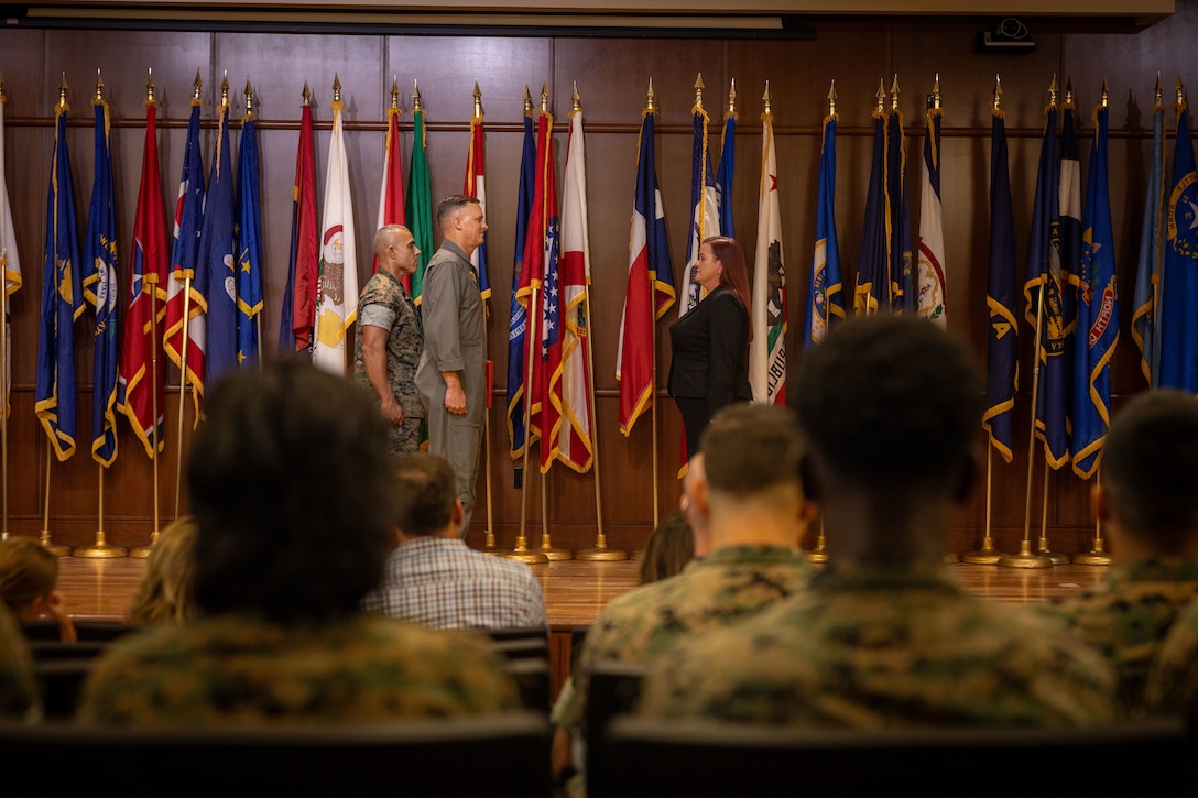 U.S. Marine Corps Lt. Gen. Leonard Anderson IV, middle, commander of Marine Forces Reserve (MARFORRES) and Marine Forces South, presents the Junior Civilian of the Year award to Lauren Yaw, muster program manager, Marine Corps Individual Support Activity, MARFORRES, during the Marine Forces Reserve 2024 Civilian of the Year awards at Marine Corps Support Facility New Orleans, July 23, 2025. Yaw received the junior Civilian of the Year award for executing and planning 30 Inactive Ready Reserve musters for Marines worldwide. (U.S. Marine Corps Photo by Lance Cpl. Edward Spears)