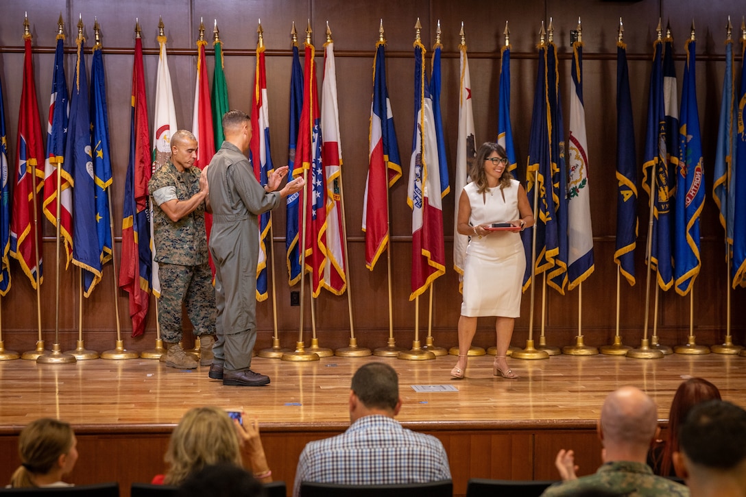U.S. Marine Corps Lt. Gen. Leonard Anderson IV, middle, commander of Marine Forces Reserve (MARFORRES) and Marine Forces South, presents the Senior Civilian of the Year award to Debbie Wanko, deputy assistant chief of staff G-8, MARFORRES, during the Marine Forces Reserve 2024 Civilian of the Year awards at Marine Corps Support Facility New Orleans, July 23, 2025. Wanko received the senior Civilian of the Year award for her expert knowledge, fiscal readiness and operational effectiveness as she managed a budget of $450 million, Wanko’s expertise directly contributed to a historic fiscal year ending, resulting in a 99.9 percent obligation rate and MARFORRES' first clean audit. (U.S. Marine Corps Photo by Lance Cpl. Edward Spears)