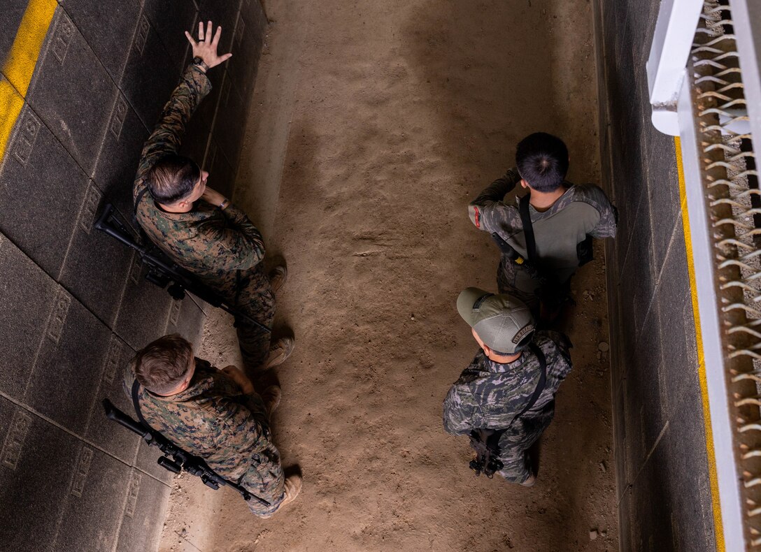 U.S. Marines with 2nd Battalion, 23rd Marines, forward deployed with 4th Marine Regiment, 3d Marine Division as part of the Unit Deployment Program, discuss military operations in urban terrain techniques with Republic of Korea Marines with 1st Marine Division, ROK, during the Korean Marine Exercise Program 25.2 in Pohang, South Korea, July 17, 2025. KMEP is conducted regularly between the ROK and U.S. Marine Corps to increase their combined capabilities through realistic training geared towards deterring threats and maintaining peace in the Indo-Pacific. (U.S. Marine Corps photo by Cpl. Kanoa Thomas)