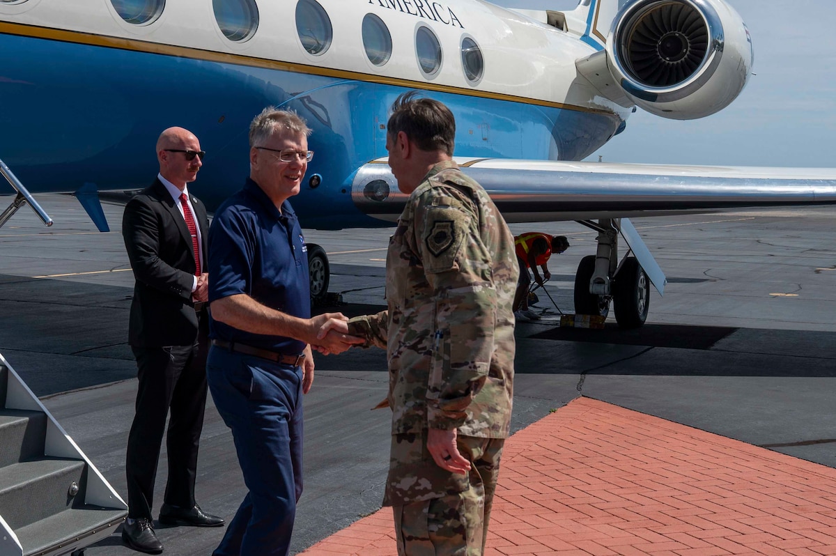 Service members shake hands