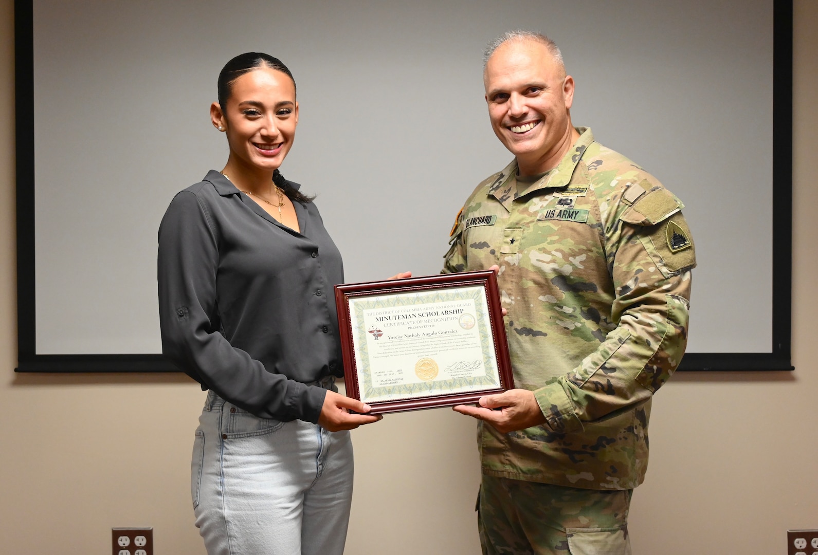 Angulo Gonzalez, a graduate of Woodbridge High School, stands for a photograph with Brig. Gen. Leland D. Blanchard II, the Adjutant General (TAG) for the D.C. National Guard, during a Minuteman Scholarship ceremony at the D.C. Armory in Washington, D.C., on July 18, 2025. Gonzalez earned a four‑year scholarship to attend Virginia Tech and plans to commission into the Judge Advocate General’s Corps.