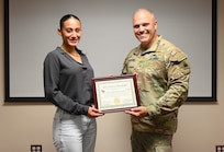 Angulo Gonzalez, a graduate of Woodbridge High School, stands for a photograph with Brig. Gen. Leland D. Blanchard II, the Adjutant General (TAG) for the D.C. National Guard, during a Minuteman Scholarship ceremony at the D.C. Armory in Washington, D.C., on July 18, 2025. Gonzalez earned a four‑year scholarship to attend Virginia Tech and plans to commission into the Judge Advocate General’s Corps.