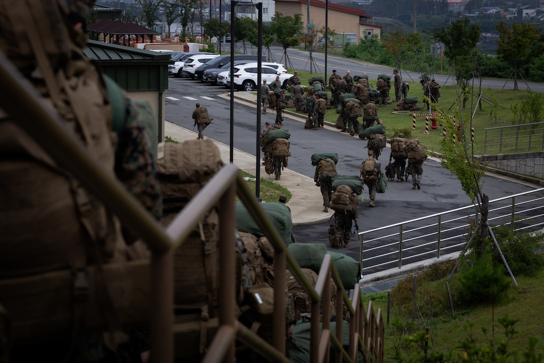 U.S. Marines with 2nd Battalion, 23rd Marines, forward deployed with 4th Marine Regiment, 3d Marine Division as part of the Unit Deployment Program, offload and stage gear upon arriving for the Korean Marine Exercise Program 25.2 at Camp Mujuk, South Korea, July 16, 2025. KMEP is a semi-annual exercise that provides iterative opportunities for Republic of Korea Marine Corps and U.S. Marine Corps units to train together, improving their combined capabilities to deter threats and maintain peace on the Korean Peninsula. (U.S. Marine Corps photo by Lance Cpl. Van Hoang)