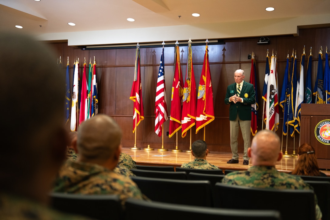 Retired U.S. Navy Capt. Mike Denkler, a director of the Order of Daedalians, speaks of the Admiral James S. Russell Naval Aviation Flight Safety Award for 2024 at Marine Corps Support Facility, New Orleans, Louisiana, July 24, 2025. The award recognizes the safety and mishap prevention practices that is cultured within military units while still effectively conducting flight operations. (U.S. Marine Corps photo by Cpl. Ujian Gosun)