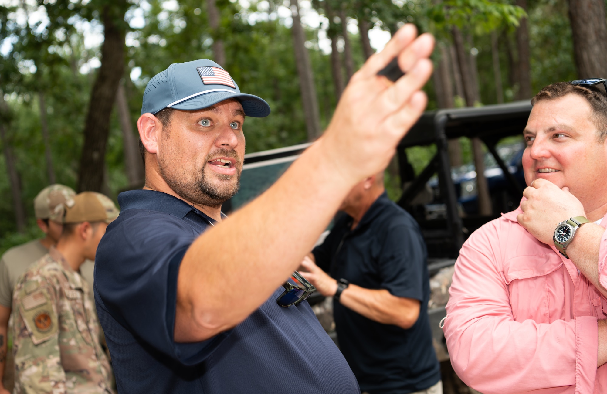 airmen learn how to use a small drone in the woods
