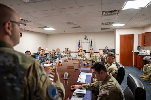  U.S. Space Force Lt. Col. Derek Haun, with the 20th Space Surveillance Squadron (20 SPSS), briefs U.S. Space Force Lt. Gen. David N. Miller, Jr. (at head of table) and the Japan Air Self-Defense Force (JASDF) team at Eglin Air Force Base, Fla., June 26, 2025.