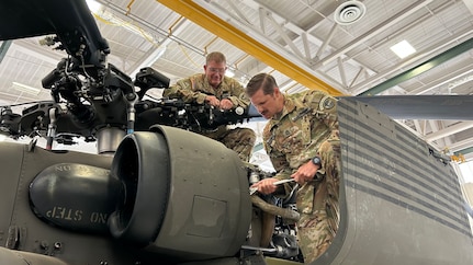 Colorado Army National Guard crew chiefs U.S. Army Sgt. 1st Class Wade Shore (left) and Sgt. 1st Class Jeremy Hubbard (right), High-Altitude Army National Guard Aviation Training Site, perform maintenance on their UH-60 Black Hawk helicopter, in Gypsum, Colorado, July 23, 2025.