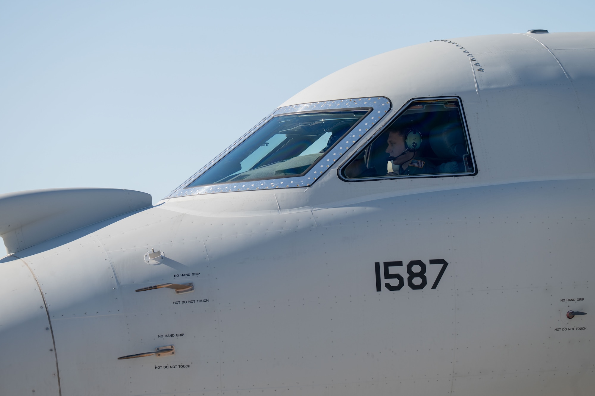 A U.S. Air Force pilot assigned to the 43rd Electronic Combat Squadron performs preflight checks in an EA-37B Compass Call aircraft at Davis-Monthan Air Force Base, Arizona, July 24, 2025. U.S. Air Force pilots have trained with the EA-37B at Davis-Monthan since August 2024. (U.S. Air Force photo by Airman Jaden Kidd)