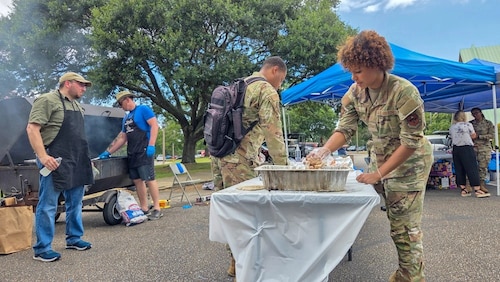 Airmen assigned to Maxwell Air Force Base prepare food during an inter-faith picnic at Maxwell Air Force Base, Ala. July 24, 2025. The picnic was hosted by the 42d ABW Chapel and brought together a wide range of off-base religious organizations with the aim to foster community and strengthen partnerships between military personnel and the diverse faith traditions represented throughout the Montgomery area. (U.S. Air Force photo by Senior Airman Evan Porter)
