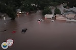 Cars underwater in a neighborhood.