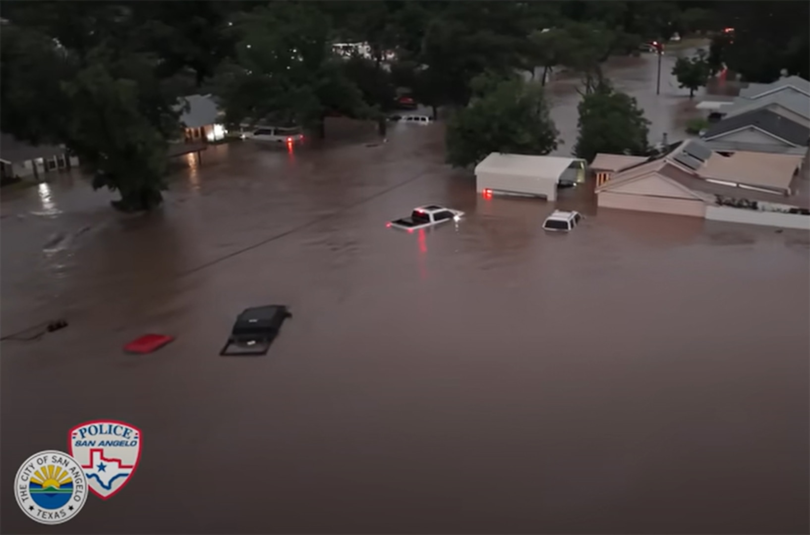 Cars underwater in a neighborhood.