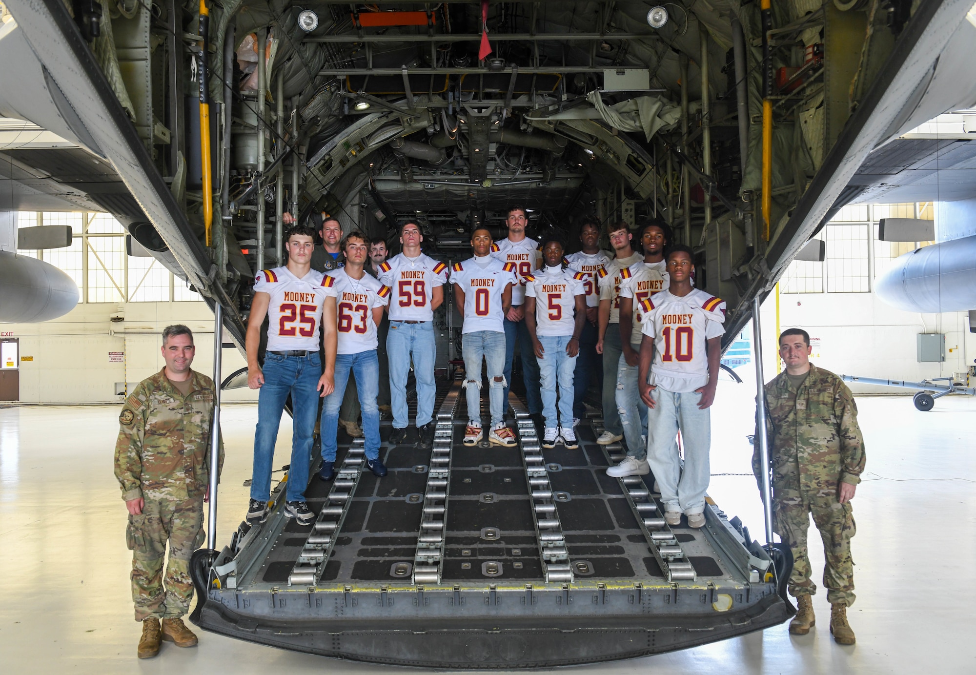 Cardinal Mooney High School senior football players pose for a group photo on the ramp of a C-130H Hercules during a tour of Youngstown Air Reserve Station, Ohio, July 25, 2025.