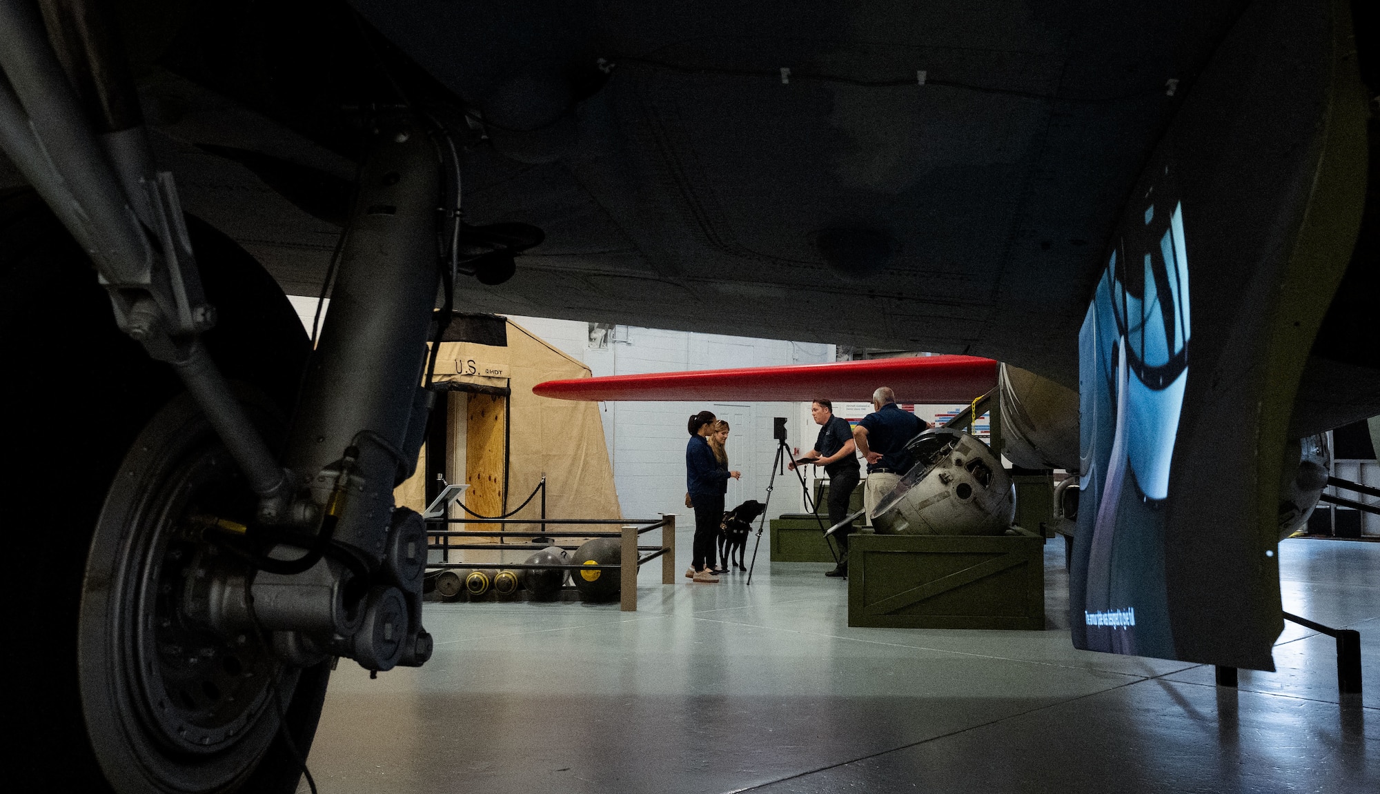 Sarah Barksdale and Meaghan Kacmarcik, 316th Wing historian office and Earl Bagwell, 316th Wing  SparkX Cell Innovation and Idea Center innovation officer, work with museum staff to capture 3D scans in the Air Mobility Command Museum at Dover Air Force Base, Del., June 4, 2025.