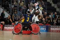 U.S. Army Staff Sgt. Derrick Thompson looks to pass the ball during a wheelchair rugby match against Team Navy at the 2025 Department of Defense Warrior Games in Colorado Springs, Colorado, July 22, 2025.