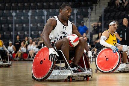 U.S. Army Master Sgt. Earlie Brown takes the ball toward the goal during a wheelchair rugby match against Team Navy at the 2025 Department of Defense Warrior Games in Colorado Springs, Colorado, July 22, 2025.
