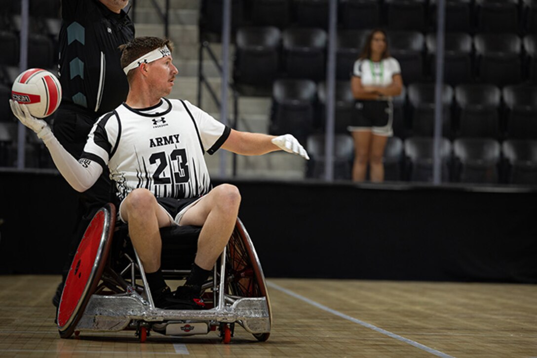 U.S. Army Staff Sgt. Coty Tuck looks to pass the ball inbound during a wheelchair rugby match against Team Navy at the 2025 Department of Defense Warrior Games in Colorado Springs, Colorado, July 22, 2025.