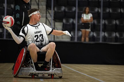 U.S. Army Staff Sgt. Coty Tuck looks to pass the ball inbound during a wheelchair rugby match against Team Navy at the 2025 Department of Defense Warrior Games in Colorado Springs, Colorado, July 22, 2025.