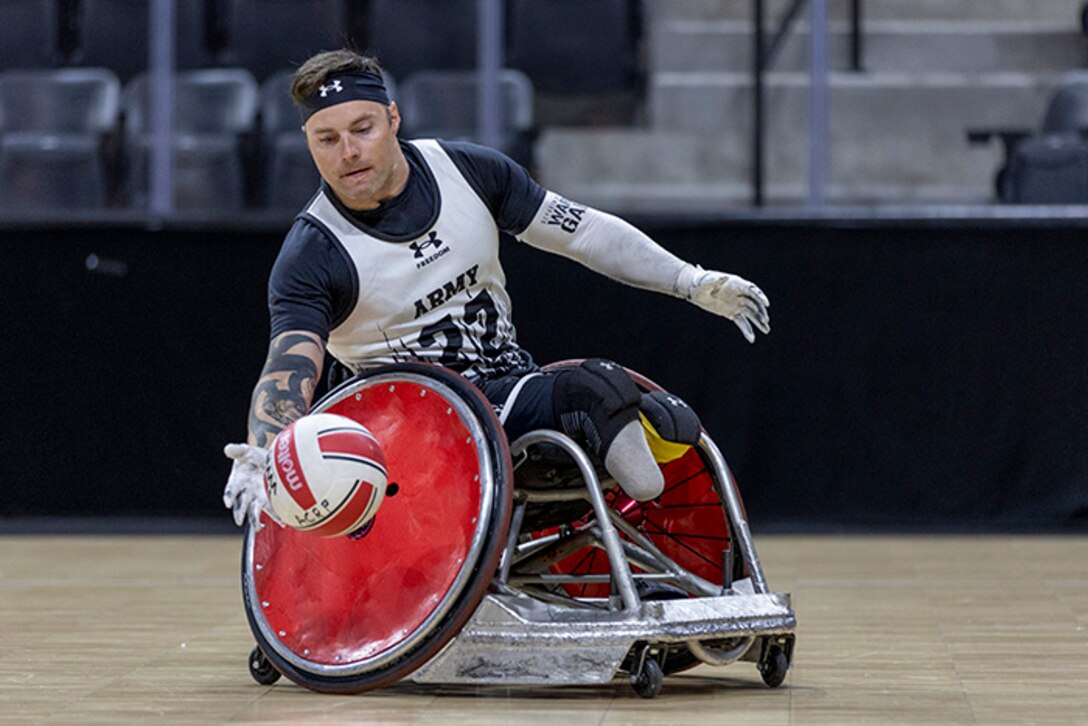 U.S. Army Retired JP Lane reaches for the ball in the wheelchair rugby event during the 2025 Department of Defense Warrior Games at Colorado Springs, Colorado, July 22, 2025.