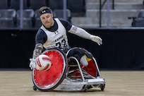 U.S. Army Retired JP Lane reaches for the ball in the wheelchair rugby event during the 2025 Department of Defense Warrior Games at Colorado Springs, Colorado, July 22, 2025.