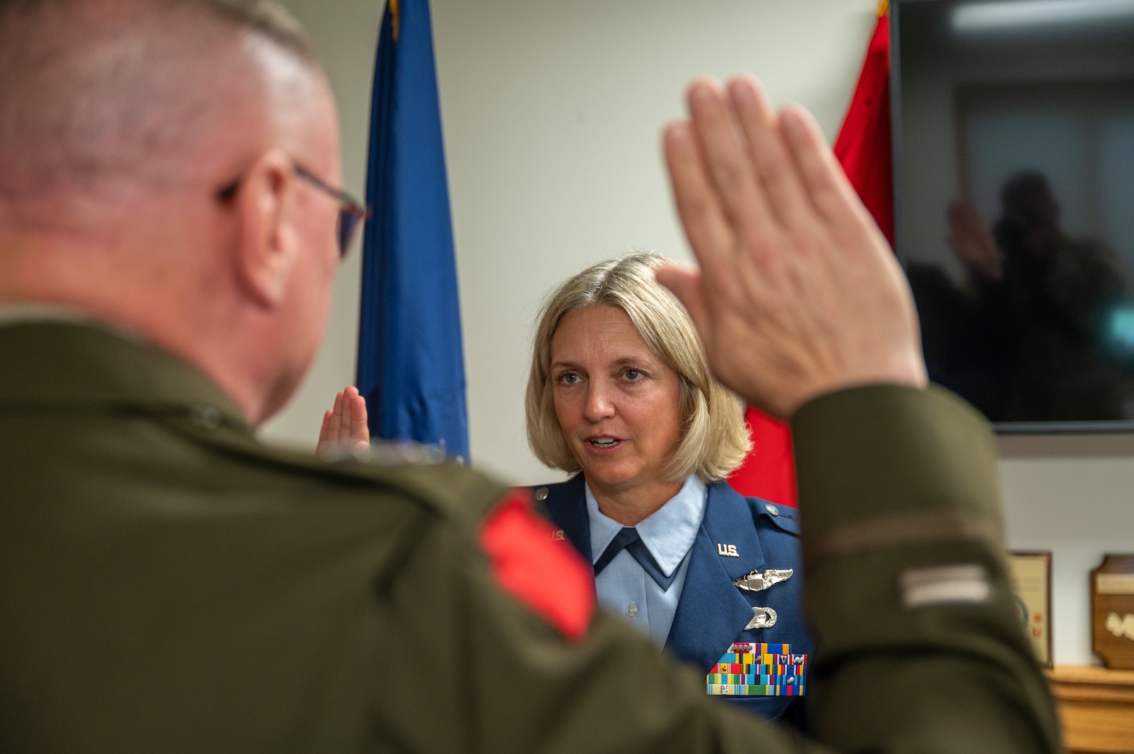 Photo of U.S. Army Maj. Gen. Gregory Knight, adjutant general of the Vermont National Guard, administering the oath to U.S. Air Force Brig. Gen. Laura Caputo following her pinning ceremony at Camp Johnson in Colchester, Vermont, July 25, 2025.