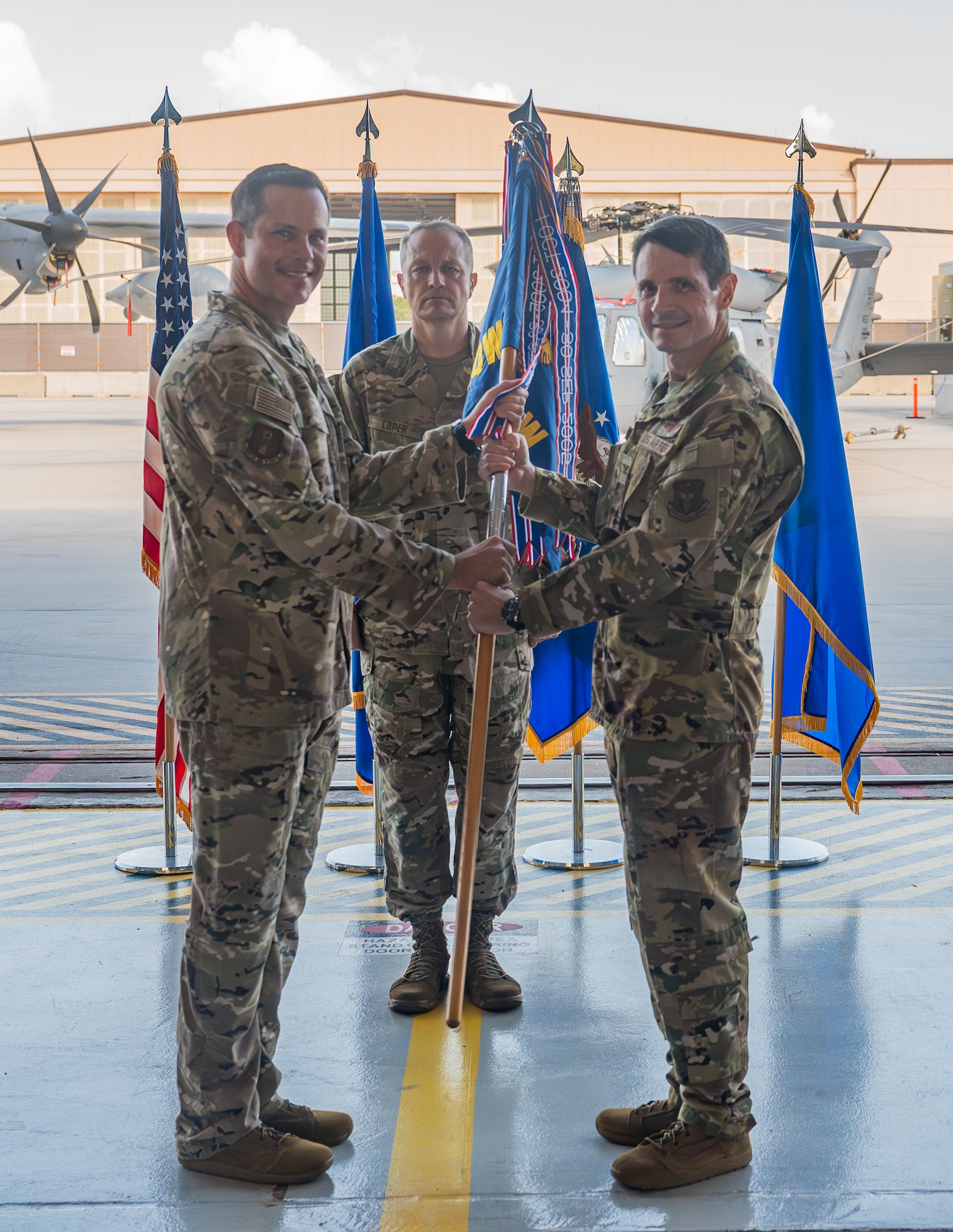 Brig. Gen. Kevin Merrill presents the guidon to Col. John Bissell.