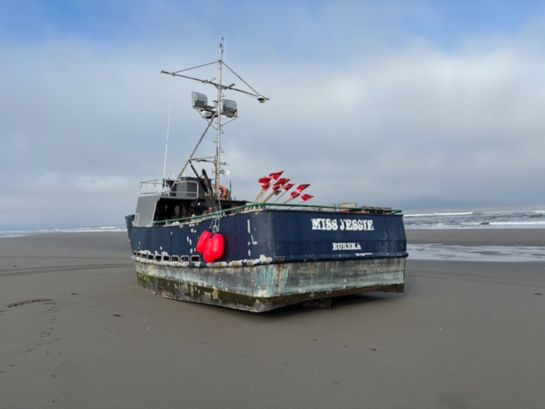 The name "Miss Jessie" is seen on the stern of a beached fishing vessel