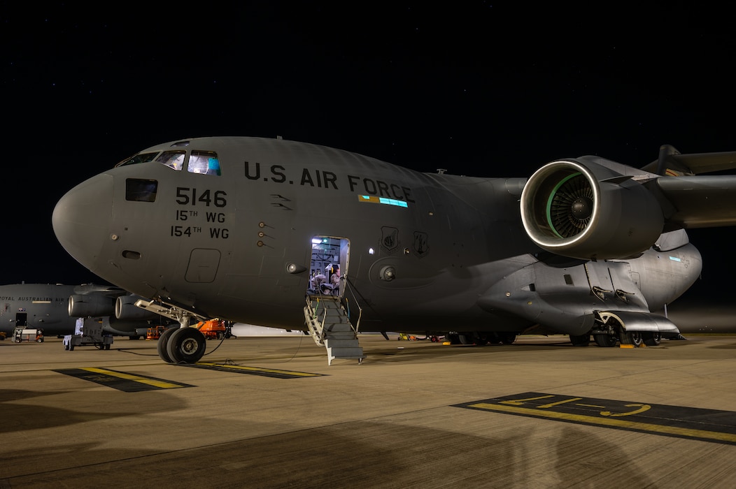 A C-17 Globemaster III assigned to the 15th Wing, Joint Base Pearl Harbor-Hickam, Hawaii, sits on the flight line at Royal Australian Air Force Base Amberley, Queensland, Australia, July 22, 2025, following a joint forcible entry operation during Talisman Sabre 2025.