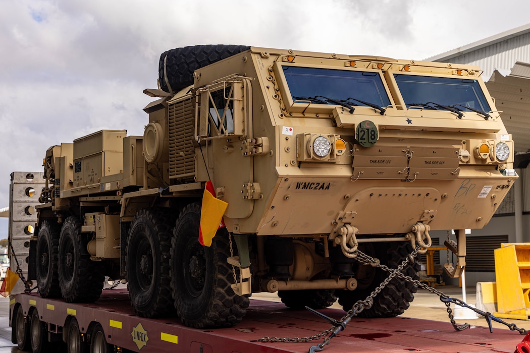 Soldiers of the 8th Theater Sustainment Command work alongside contracted civilian support to load military vehicles and equipment in preparation for exercise Talisman Sabre 25 at south Bandiana, northeast Victoria, Australia, June 15, 2025.