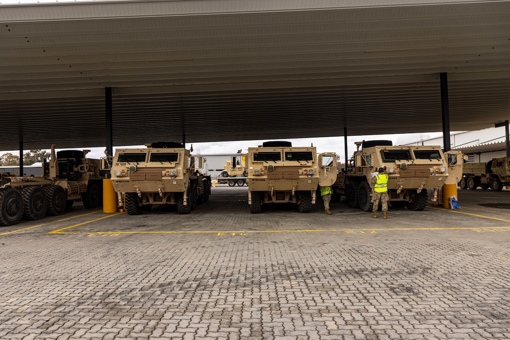 Soldiers of the 8th Theater Sustainment Command work alongside contracted civilian support to load military vehicles and equipment in preparation for exercise Talisman Sabre 25 at south Bandiana, northeast Victoria, Australia, June 15, 2025.
