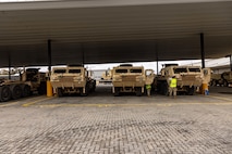 Soldiers of the 8th Theater Sustainment Command work alongside contracted civilian support to load military vehicles and equipment in preparation for exercise Talisman Sabre 25 at south Bandiana, northeast Victoria, Australia, June 15, 2025.