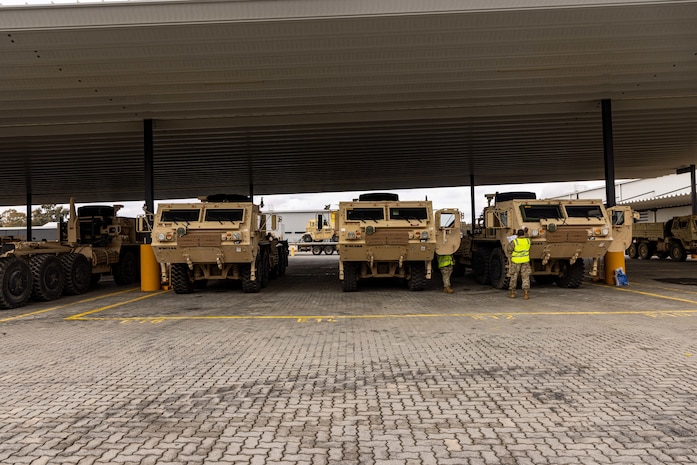 Soldiers of the 8th Theater Sustainment Command work alongside contracted civilian support to load military vehicles and equipment in preparation for exercise Talisman Sabre 25 at south Bandiana, northeast Victoria, Australia, June 15, 2025.