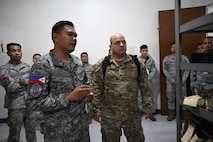 U.S. Air Force Tech. Sgt. Randy Russe-Rodriguez, 36th Tactical Advisor Squadron air advisor, speaks with Philippine Air Force members during a subject matter expert exchange at Basa Air Base, Philippines, July 10, 2025.