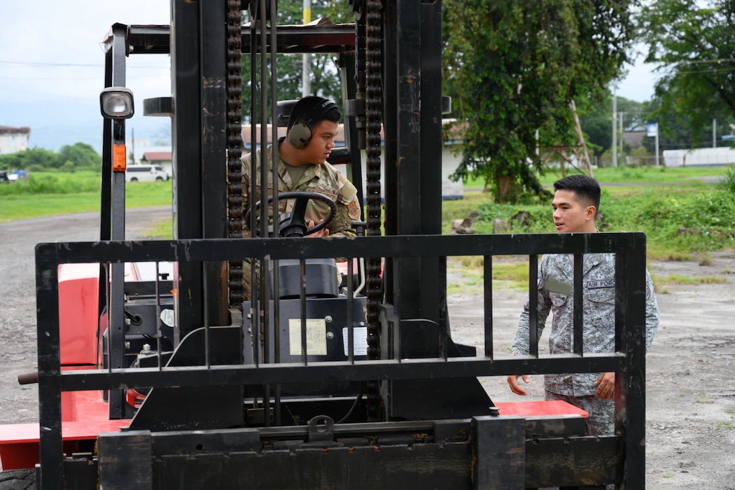 U.S. Air Force Senior Airman Ely Pocaigue, 44th Aerial Port Squadron air transportation specialist, speaks with a Philippine Air Force member during a subject matter expert exchange at Basa Air Base, Philippines, July 9, 2025.