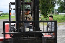U.S. Air Force Senior Airman Ely Pocaigue, 44th Aerial Port Squadron air transportation specialist, speaks with a Philippine Air Force member during a subject matter expert exchange at Basa Air Base, Philippines, July 9, 2025.