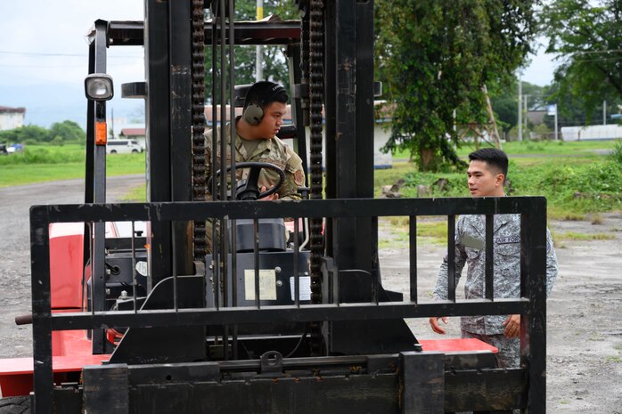 U.S. Air Force Senior Airman Ely Pocaigue, 44th Aerial Port Squadron air transportation specialist, speaks with a Philippine Air Force member during a subject matter expert exchange at Basa Air Base, Philippines, July 9, 2025.