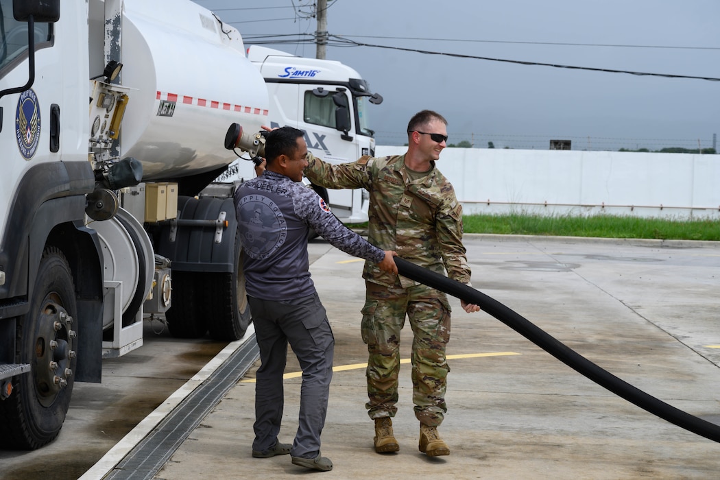 U.S. Air Force Tech. Sgt. Richard Bazell, right, 36th Tactical Advisory Squadron air advisor, and Philippine Air Force Staff Sgt. Jay Mendoza, 541st Supply Squadron fuels manager, guide a fuel hose during a subject matter expert exchange at Basa Air Base, Philippines, July 9, 2025.