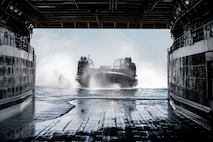 landing craft, air cushion, assigned to Assault Craft Unit (ACU) 5 approaches the well deck of amphibious transport dock ship USS Somerset (LPD 25) while underway in the Pacific Ocean, July 24, 2025.