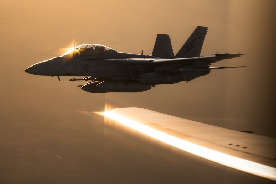 A Royal Australian Air Force F/A-18F Super Hornet aircraft flies alongside a U.S. Air Force KC-46 Pegasus aircraft from Travis Air Force Base, California, during an aerial refueling mission as part of Talisman Sabre 25 over the Northern Territory, Australia, July 17, 2025.